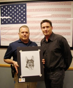 Chief Moulas accepts my memorial portrait of his former K-9 partner, Qai.
